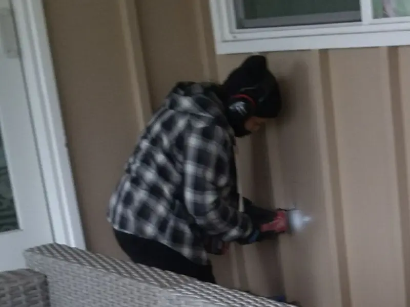 Professional electrician installing an exterior outlet in Winslow